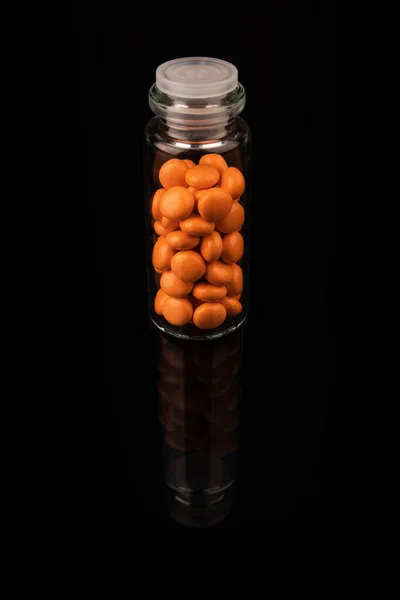 Valerian in a bottle on a black background, mirroring. Space for text. — Fotografia de Stock