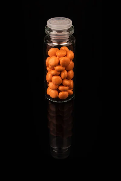 Valerian in a bottle on a black background, mirroring. Space for text. Stock Picture