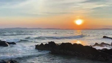 Romantik Van Chay plajında, öğleden sonra güneşli, parlak altın güneş ışığı altında yürüyen turistler. Bu çekim, engin doğal uzayın ortasındaki insan deneyimi aktivitelerini yakalar. Van Chay Sahili, Co To Adası, Quang Ninh, Vietnam 'da yakalandı.