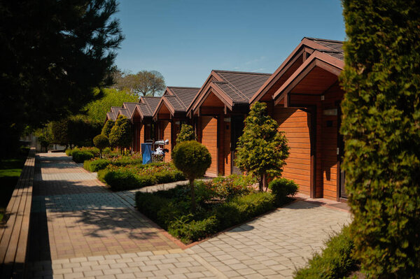 a maid trolley for cleaning rooms in a country hotel is near the bungalow