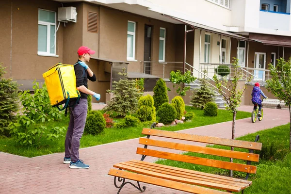 delivery, mail and people concept happy man delivering food in disposable paper bag to customer home