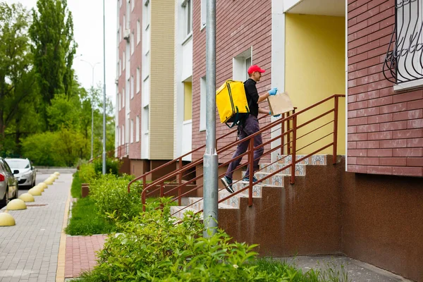 delivery, mail and people concept happy man delivering food in disposable paper bag to customer home