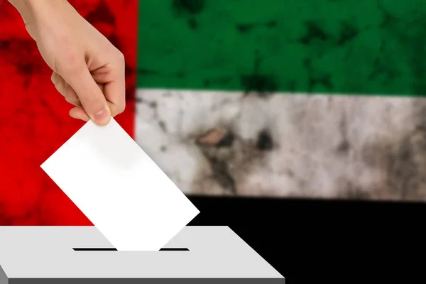 hand drops the ballot election against the background of the flag, concept of state elections, referendum