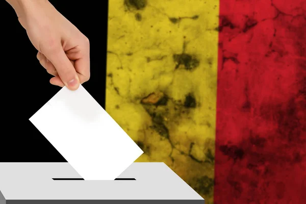 hand drops the ballot election against the background of the flag, concept of state elections, referendum