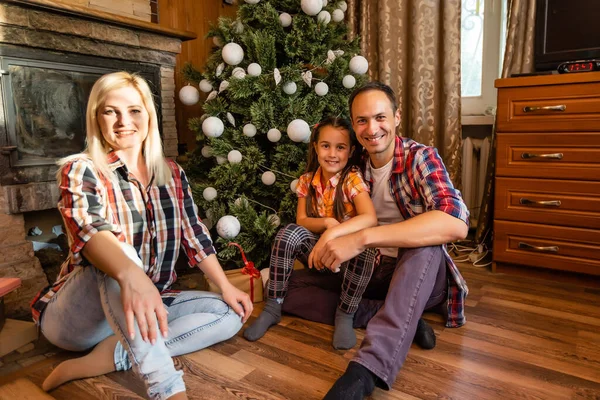 Family in an old wooden house. Beautiful christmas decorations. The festive mood. Christmas holidays.