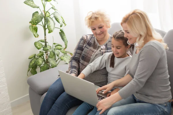 stock image Grandmother and daughter teaching child use laptop application, playing game