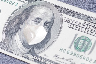  ABD 'de COVID-19 Coronavirus, yüz maskeli 100 dolarlık para. Coronavirus küresel borsayı etkiliyor