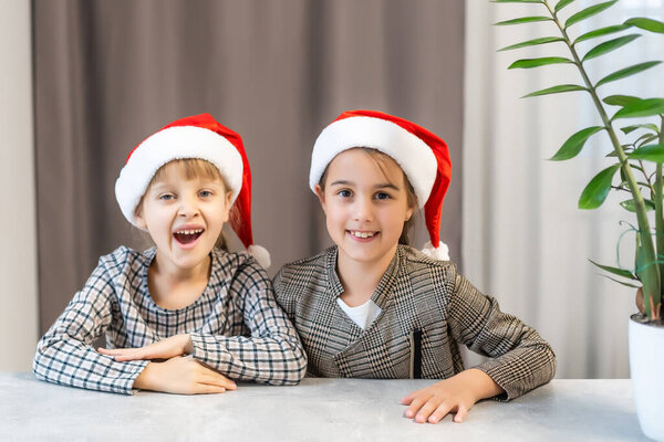 Christmas Happy funny children twins sisters in santa hats