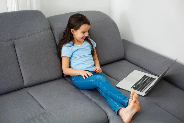 ev, eğlence, teknoloji ve internet konsepti - evde dizüstü bilgisayarı olan küçük kız öğrenci