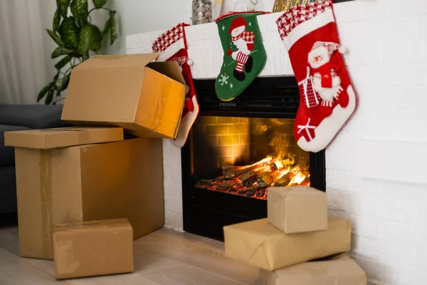 delivery christmas gifts. delivery boxes near fireplace before christmas