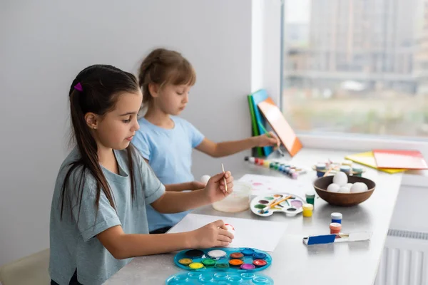 Two Happy Cute Girls Sisters Paint Easter Eggs Laugh Show — Stock Photo, Image