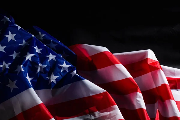 stock image American flag lying on black background