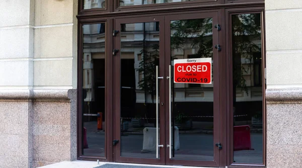 Business center closed due to COVID-19, sign with sorry in door window. Stores, restaurants, offices, other public places temporarily closed during coronavirus pandemic. Economy hit by corona virus.