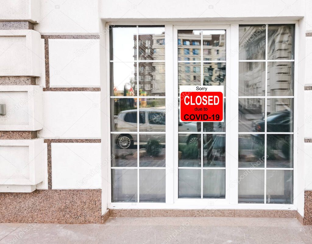 Business center closed due to COVID-19, sign with sorry in door window. Stores, restaurants, offices, other public places temporarily closed during coronavirus pandemic. Economy hit by corona virus.