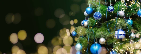 お祭り騒ぎの閉鎖ぼやけた輝く妖精の背景に明るい赤いボールを持つ屋外クリスマスツリー ガーランドライトを使用しないと ボケ効果 高品質の写真 ロイヤリティフリーのストック画像