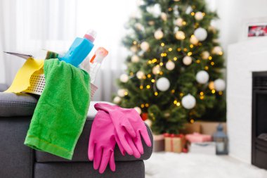 Noel 'den önce temizlik. Çok renkli temizlik malzemeleri. Süngerler, paçavralar ve spreyler modern ev arka planına karşı şenlikli dekorasyonlar