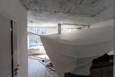 Tamirciler PVC vinil filmden yapılmış esnek tavanı gaz tabancasıyla kuruyorlar.