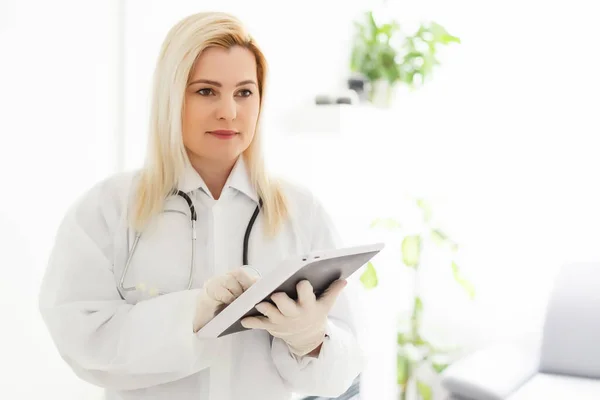 Female Doctor Holding Tablet PC. Doctor\'s hands close-up. Medical service and health care concept.