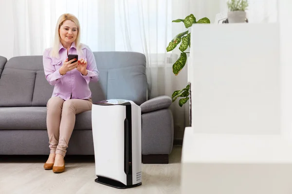 Young Woman Relaxing Couch While Air Humidifier Purifier Working Foreground — Stock Photo, Image