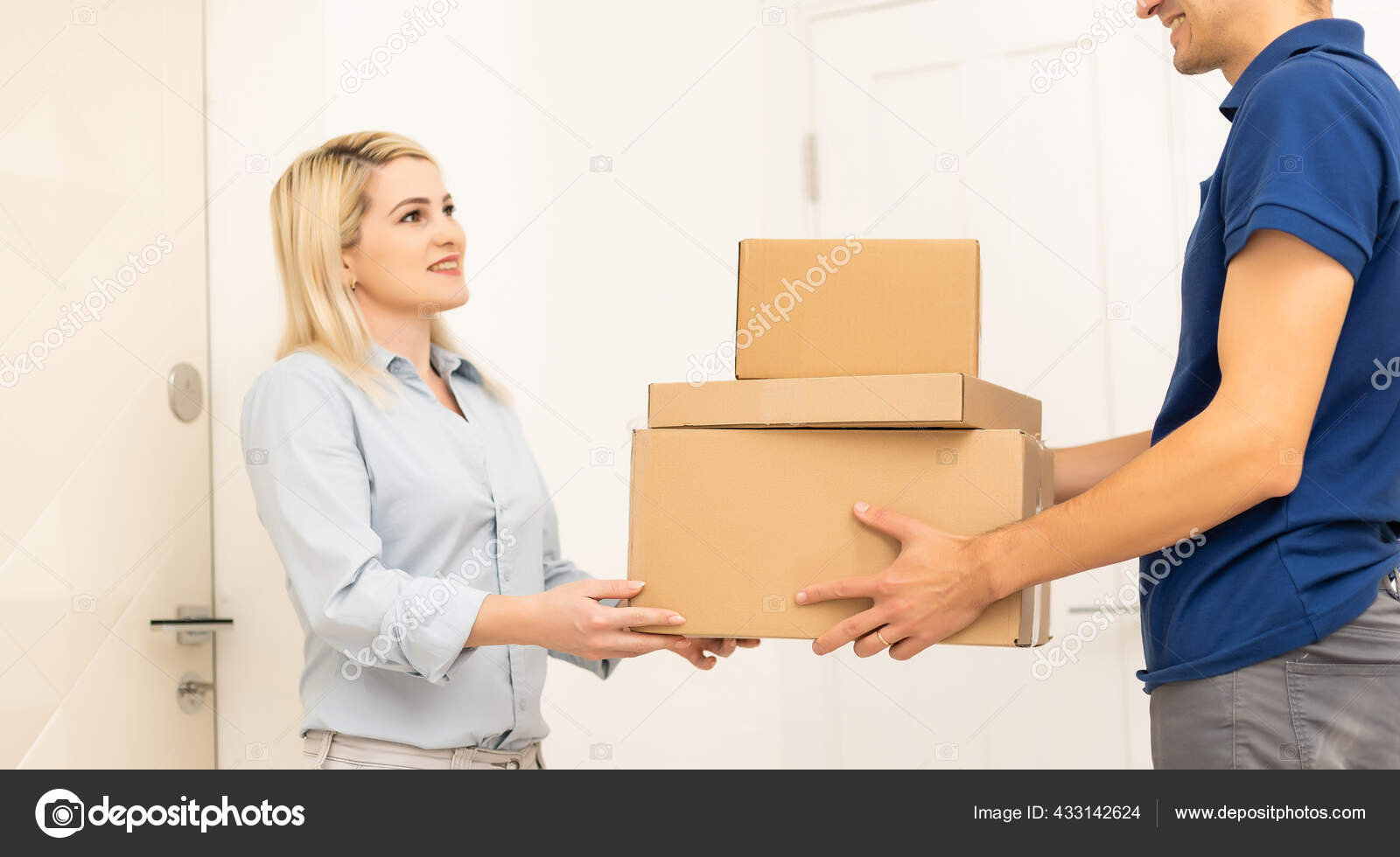 Smiling Delivery Man Giving Boxes Woman Customer Home Online Shopping Stock Photo by ©sinenkiy