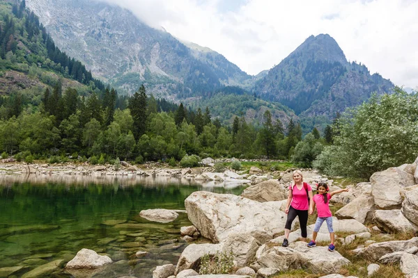 Anne ve kızı İtalya Gölü yakınlarındaki dağlarda yürüyorlar.