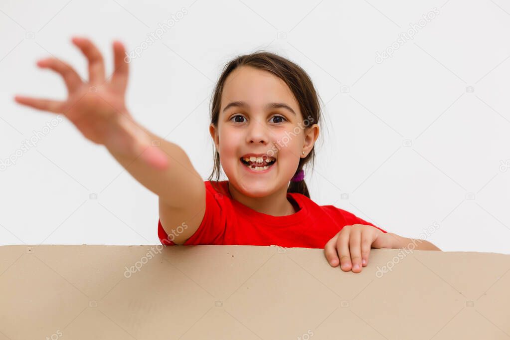 Happy girl opening present. Child excited with Christmas holiday gift concept. Kid looking inside cardboard box view. Teenager getting birthday surprise idea. Person with cheerful expression