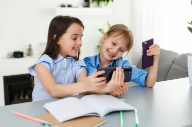 İnternette okuyan iki küçük kız. Çevrimiçi Uzaklık Öğrenme, e-öğrenme, konsept