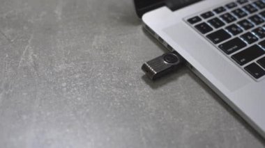 Bir USB flash bellek anahtarını bir dizüstü bilgisayarın portuna bağla.