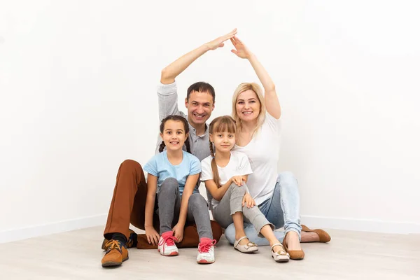 Concepto de vivienda de una familia joven. madre padre e hijos en un nuevo hogar — Foto de Stock