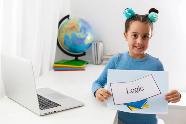 Happy little child child girl has idea. Online education for small kids. Kid studding on laptop — Stock Photo, Image