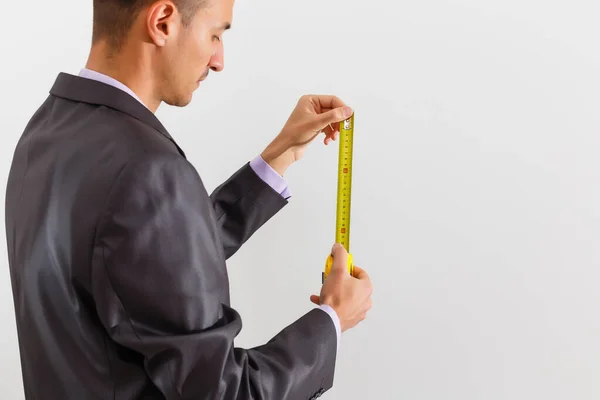 Businessman holding measurement tape, isolated on white background — Stock Photo, Image