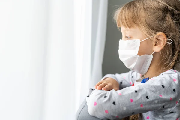 Menina doente caucasiana em máscara médica durante a epidemia de coronavírus reza — Fotografia de Stock