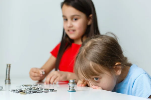 Retrato de niñas sentadas en la mesa y calculando el dinero — Foto de Stock