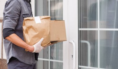 Paket yemek için çeşitli kağıt kaplar. Teslimatçı taşıyor.