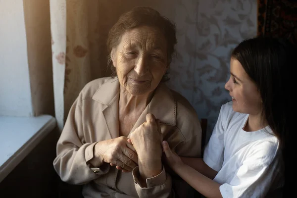 Uma menina está rindo com sua bisavó — Fotografia de Stock