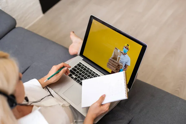 Encomendar comida conceito on-line: mulher com um laptop mostrando site fast food na tela. Gráficos de tela são compostas. — Fotografia de Stock