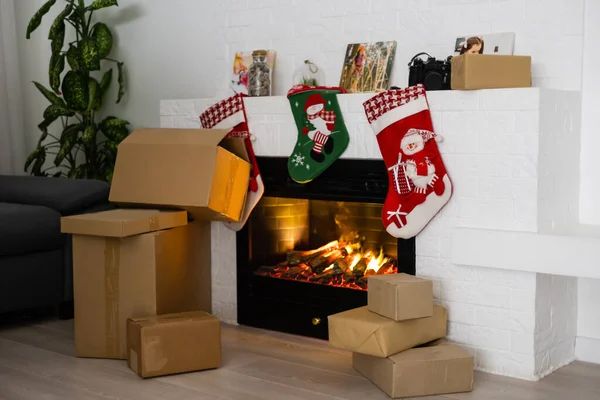 Vintage packages, delivery boxes near fireplace, Christmas — Stock Photo, Image