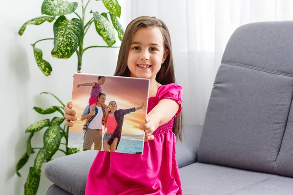 Tradition to do a photo on each birthday. little girl with photos on canvas. — Stock Photo, Image