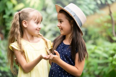 Serada kelebekleri olan iki küçük kız