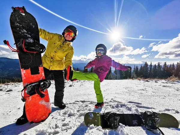 Portrait of happy family with snowboards looking at camera on blue background — Stock Photo, Image