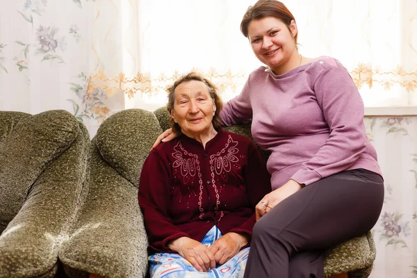 Grandmother and adult granddaughter embraced and happy — Stock Photo, Image