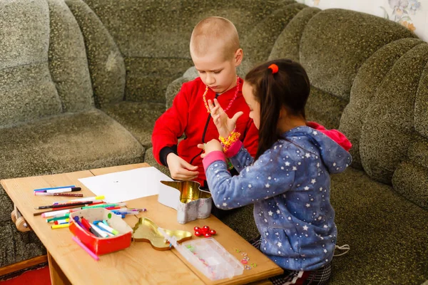 Little toddler girl and boy concentrate work together. boy and girl learn and play together at the table. Children enjoy hand writing. Friendship