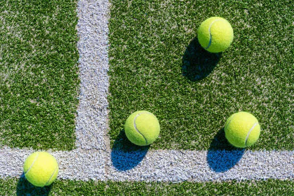 View of empty lawn tennis court with tennis ball