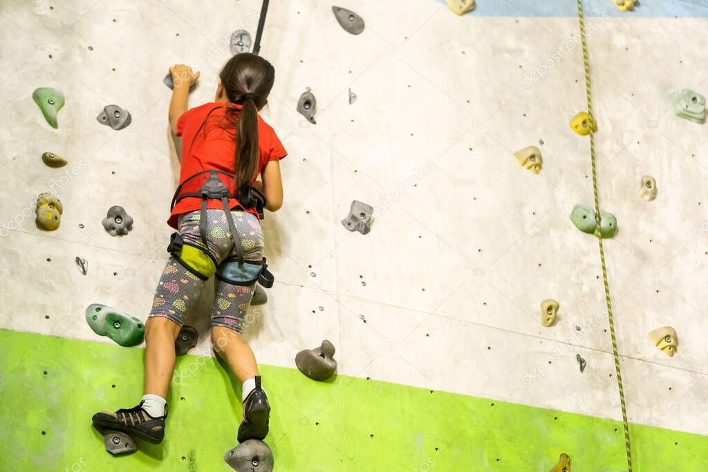 Little Girl Climbing Rock Wall