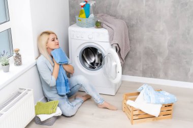 Housework, young woman doing laundry clipart