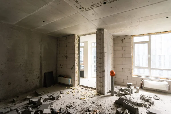 Break the wall for renovation and build the door for entrance of building. Wheelbarrow with broken bricks in site construction. — Stock Photo, Image