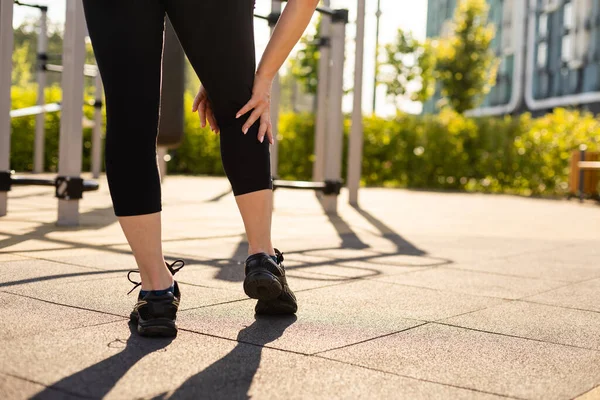 woman working out in gym on equipment outdoors having fun