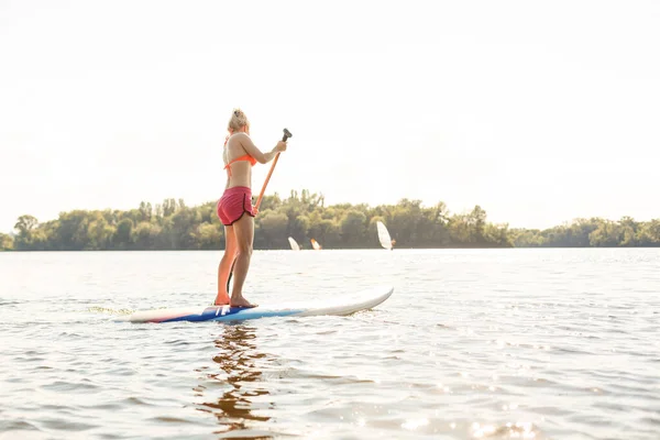 Action Shot of Young Woman on Paddle Board — Stock Photo, Image