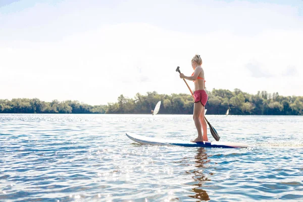 Action Shot of Young Woman on Paddle Board — Stock Photo, Image