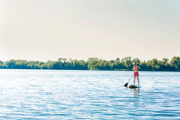 Action Shot of Young Woman on Paddle Board — Stock Photo, Image